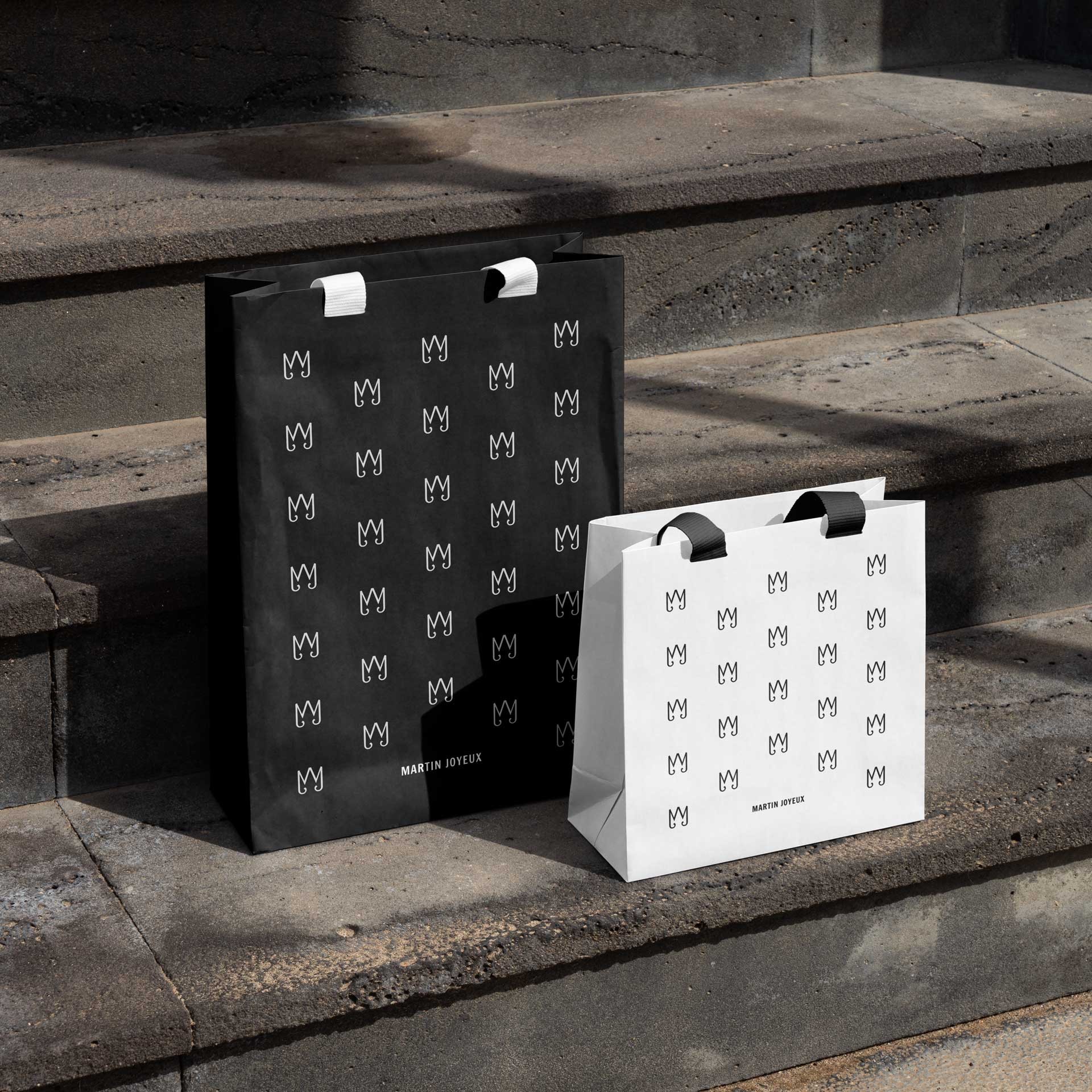 Papiertaschen von Martin Joyeux als Anwendung des Corporate Designs mit Monogramm als Muster.